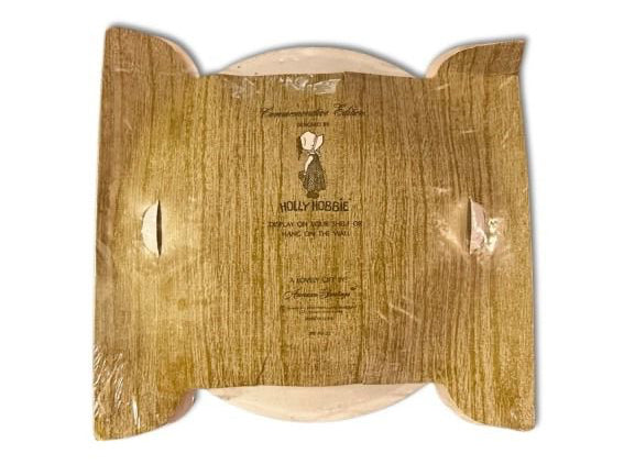 Wooden cutting board with 'Holly Hobbie' branding on a white background