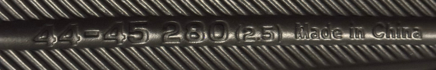 Close-up of bottom of shoe with engraved text on a carpeted floor.