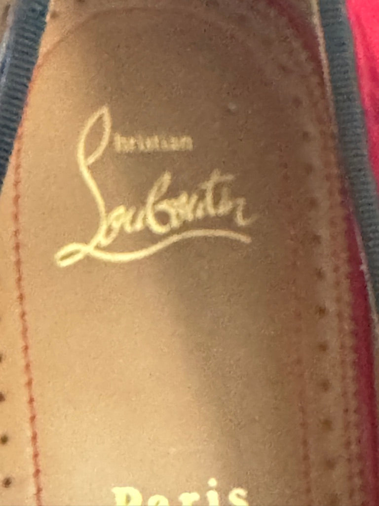 Close-up of a Christian Louboutin logo on a shoe sole.
