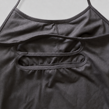 Close-up of a dark gray athletic tank top showing the back straps and double cutout details.