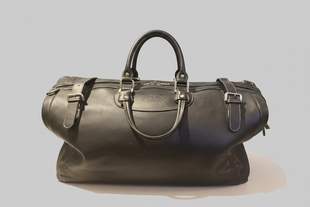 Black leather duffel bag on a table 