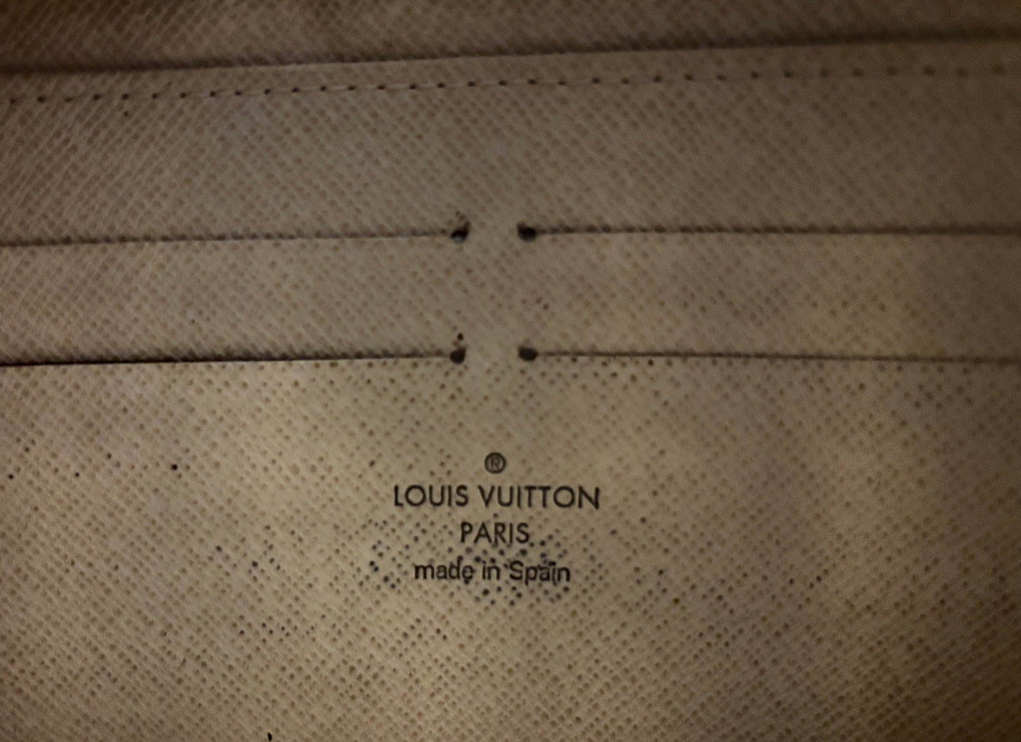 Louis Vuitton logo on a textured surface