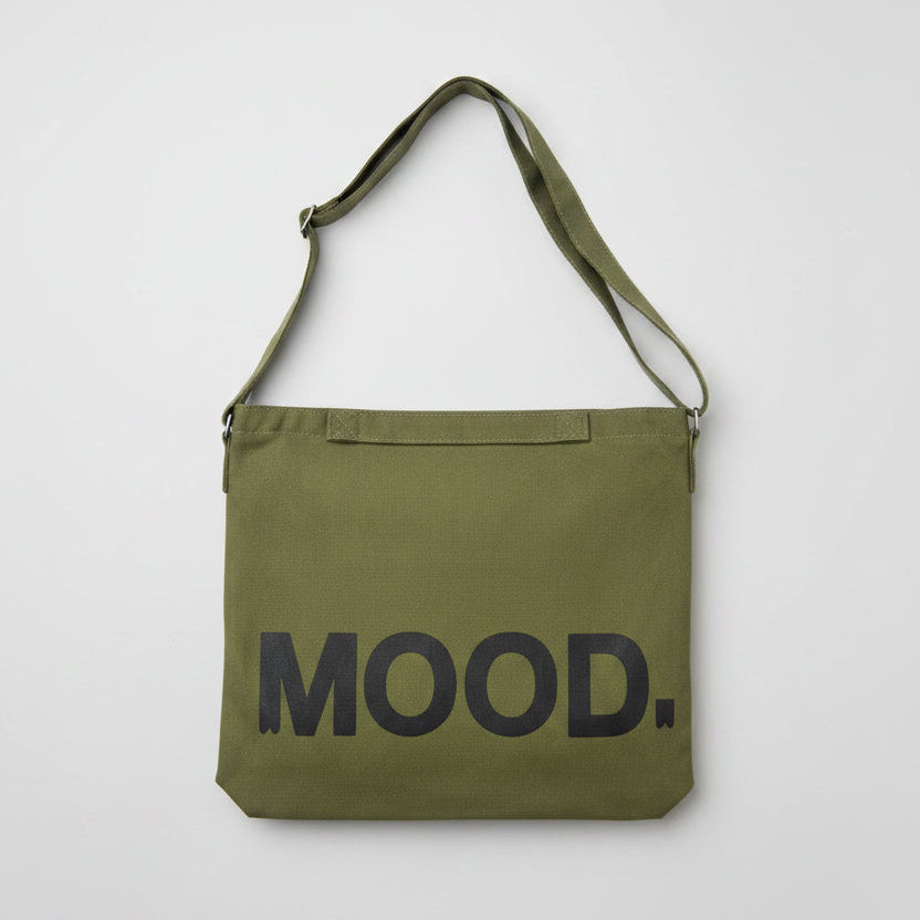Green bag with 'MOOD.' text on a white surface
