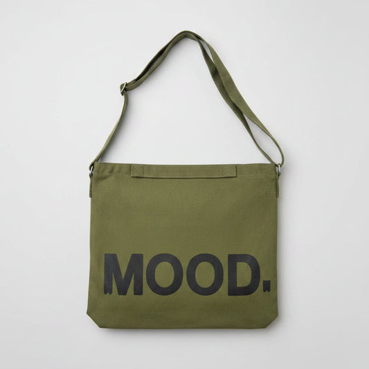 Green bag with 'MOOD.' text on a white surface