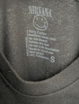 Nirvana logo on a gray sweatshirt with care label text.