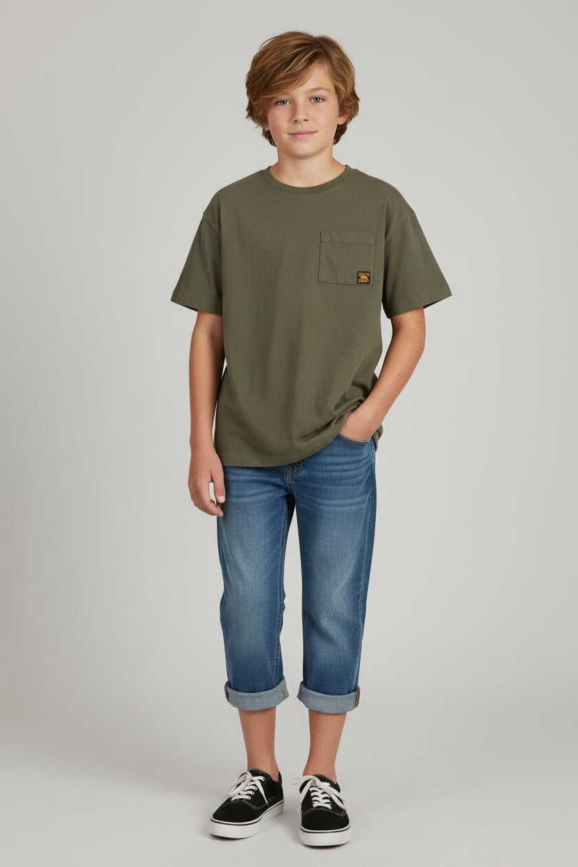 An olive green short-sleeve pocket t-shirt hanging on a white plastic hanger against a textured off-white wall.