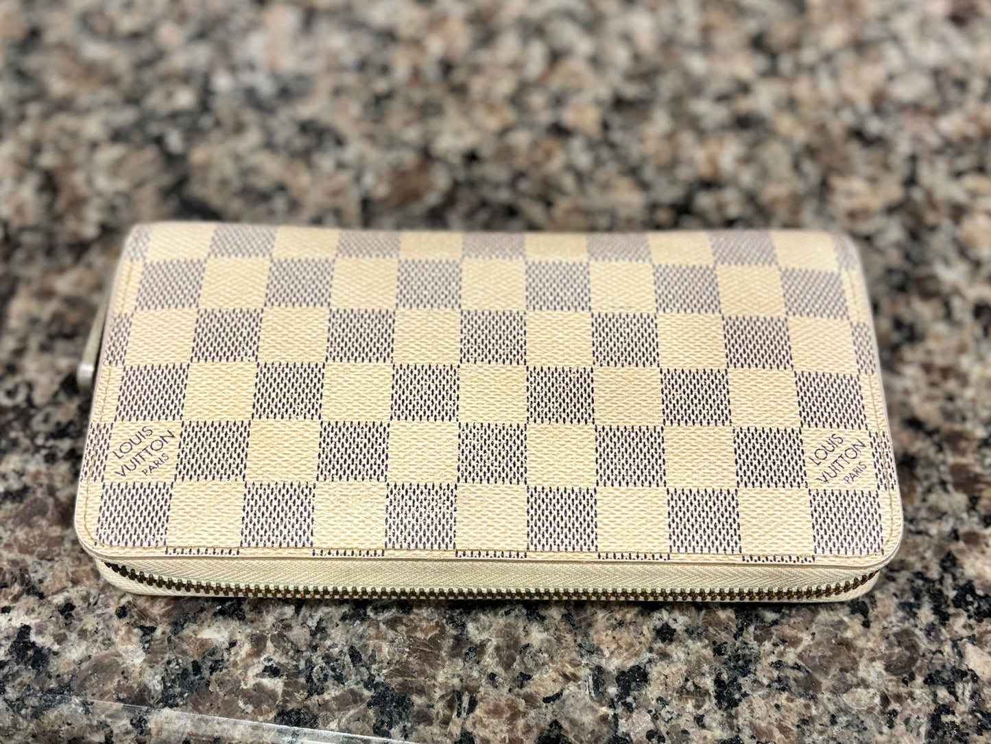 Checkered wallet on a granite surface