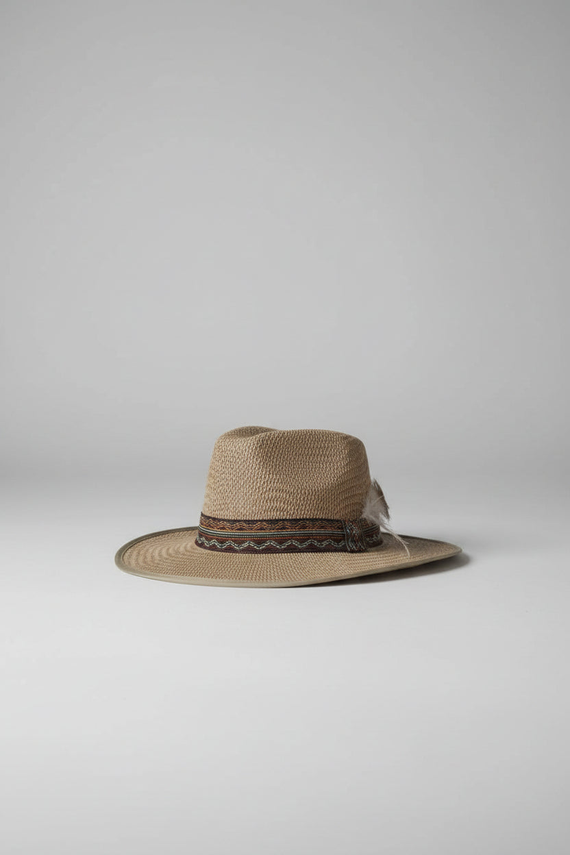 Beige straw hat with a decorative band on a carpeted floor.