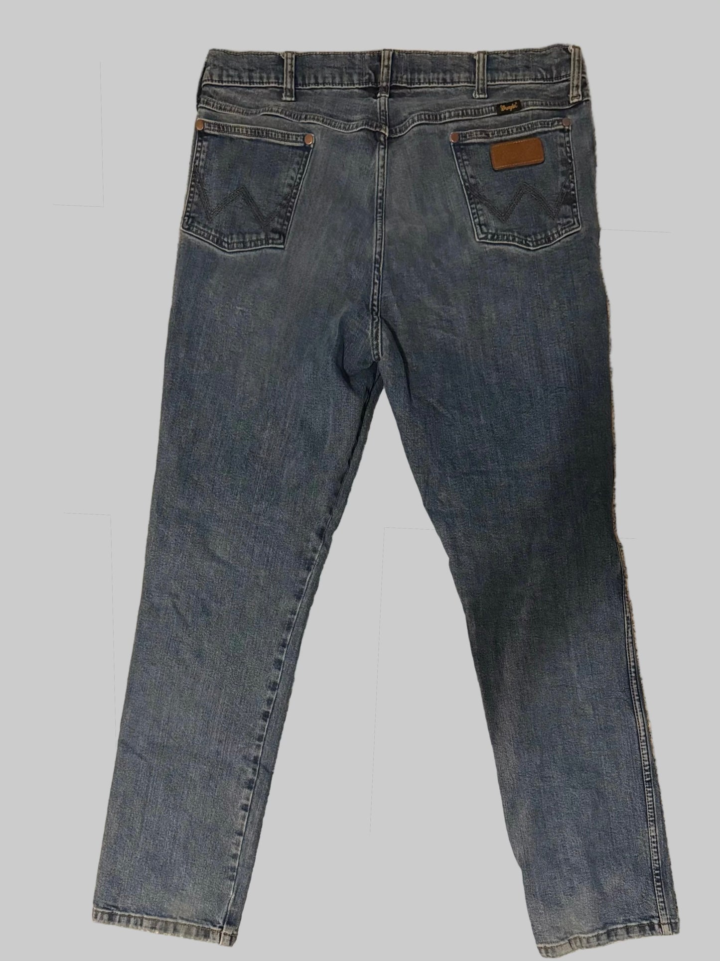 Pair of blue jeans on a gray background