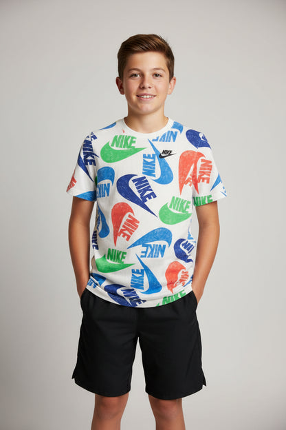 A vintage Nike short-sleeve t-shirt with a colorful all-over logo print, laid flat on a dark wooden floor.