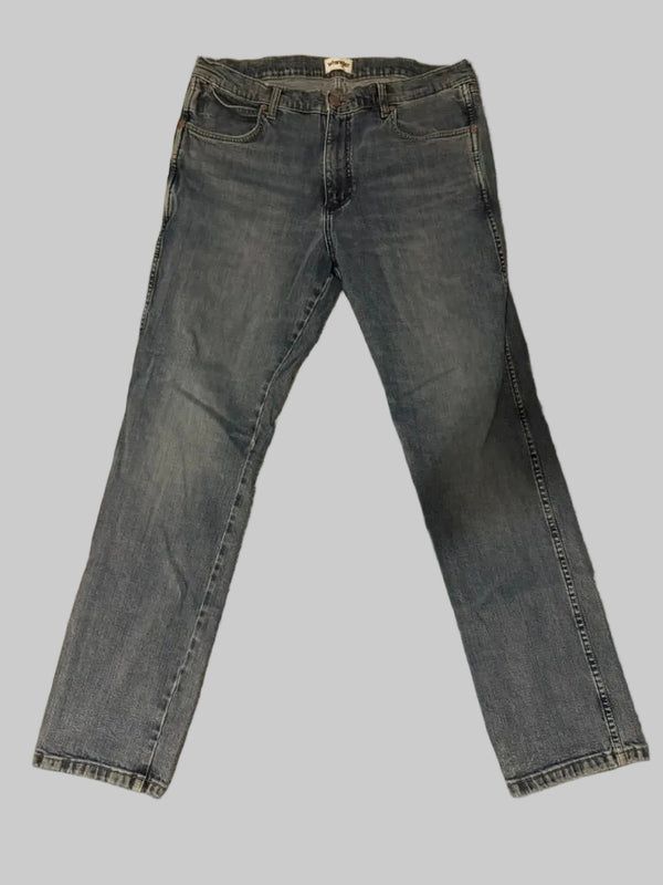 Pair of blue jeans on a beige carpet