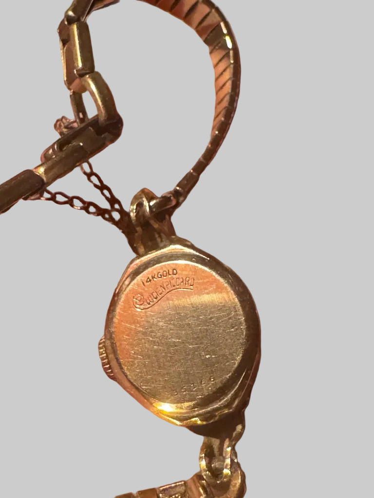 Gold watch on gray background 