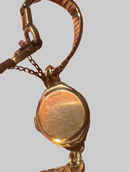 Gold watch on gray background 