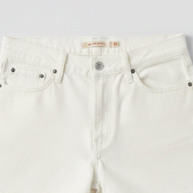 Close-up of a label on a pair of white shorts with 'Ric cage shorts' text.