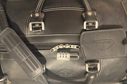 Black leather briefcase with Samsonite logo and combination lock.