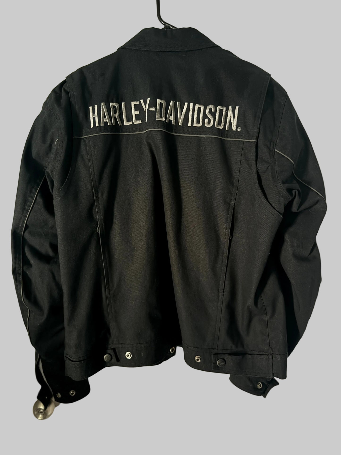 Black Harley-Davidson jacket hanging on a door