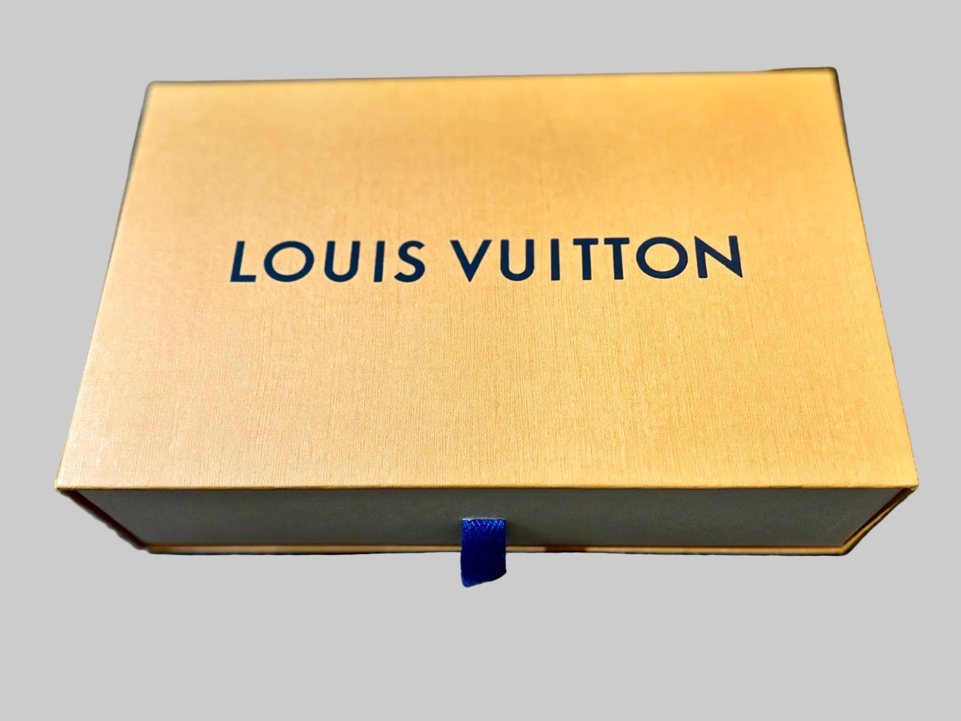 Louis Vuitton box on a blue surface