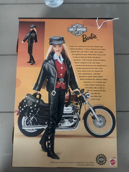 Barbie and Harley-Davidson Together 2010 Collector's Edition doll packaging, featuring a blonde doll in a black leather motorcycle jacket and pants standing next to a motorcycle on a tan background.