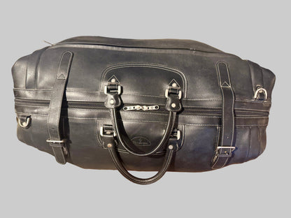 Black leather duffel bag with visible brand logo on a neutral background