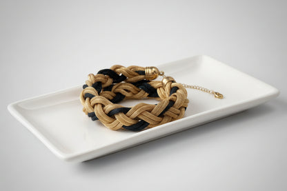 Bracelet with braided tassels on a marble surface