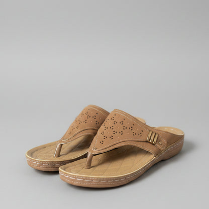 Pair of brown sandals on a wooden surface with blurred background