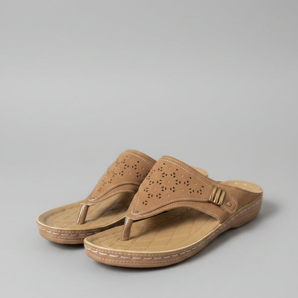 Pair of brown sandals on a wooden surface with blurred background