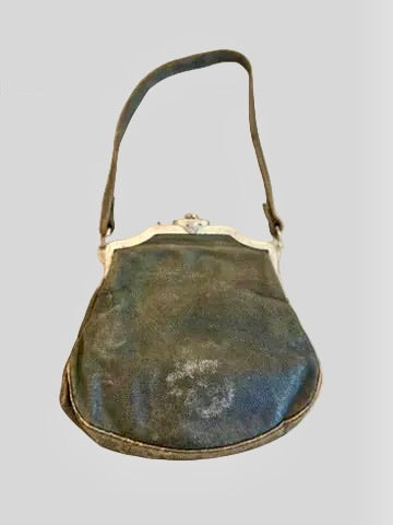 Vintage handbag with a metal frame on a gray background