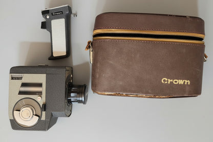 Brown leather wallet with 'Crown' branding and camera parts