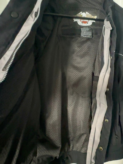 Close-up of a black jacket with a brand logo on the chest area.