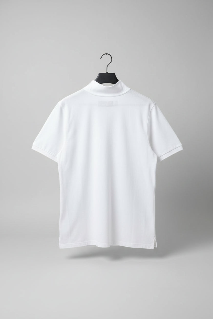 White polo shirt on a hanger against a gray carpeted floor