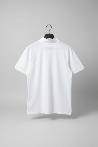 White polo shirt on a hanger against a gray carpeted floor