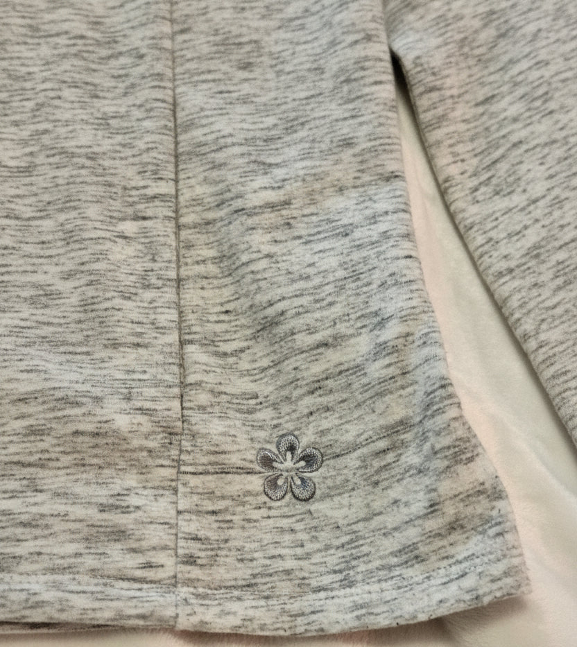 Close-up of a textured fabric with a floral button detail