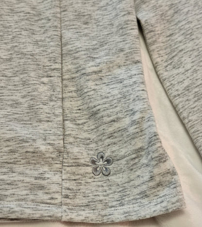 Close-up of a textured fabric with a floral button detail