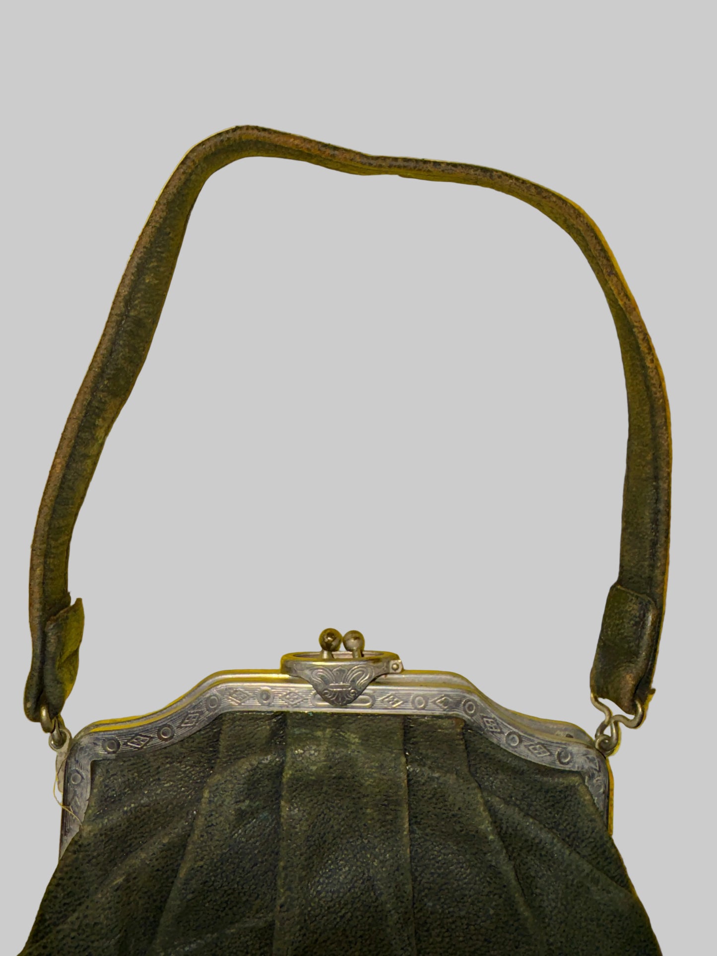 Black handbag with a strap on a yellow textured background