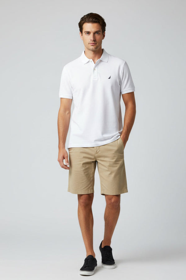 White polo shirt with a small logo on a gray surface