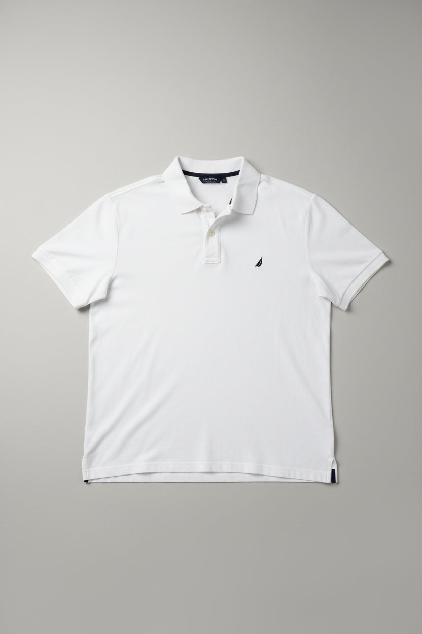 White polo shirt with a small logo on a gray surface