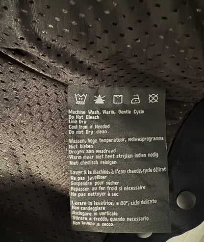 Clothing label with care instructions on a textured fabric background