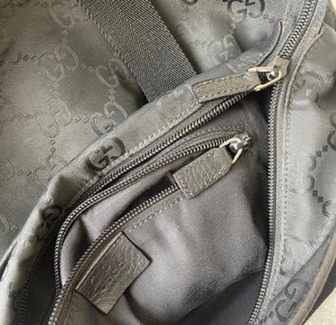 Close-up of a Gucci bag with a visible logo pattern.
