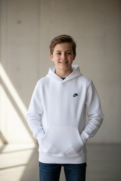 A white Nike pullover hoodie with a small black Swoosh logo on the left chest, displayed flat against a solid gray background.