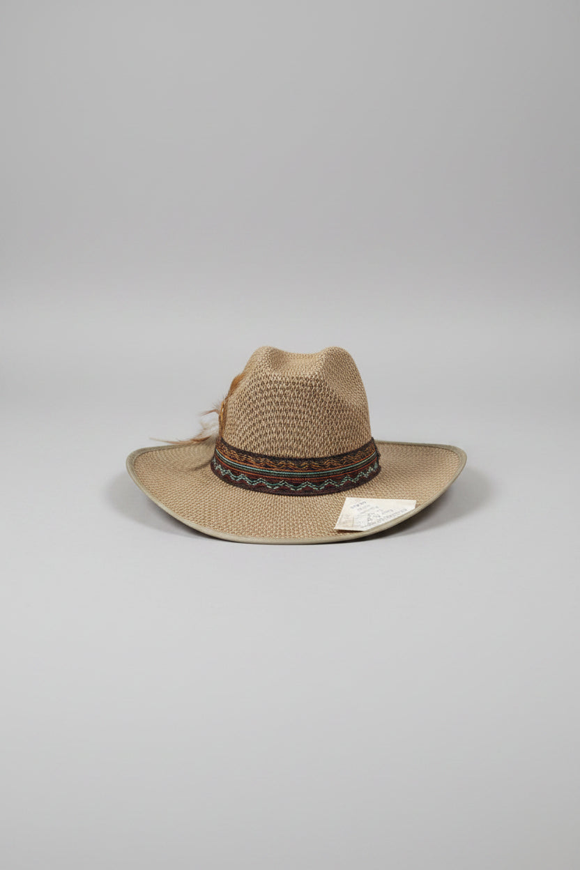 Brown straw hat with a band on a textured surface
