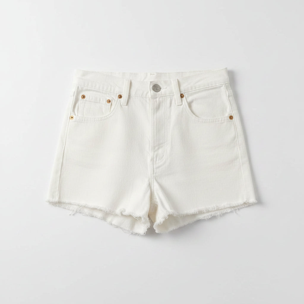 White denim shorts on a textured gray surface