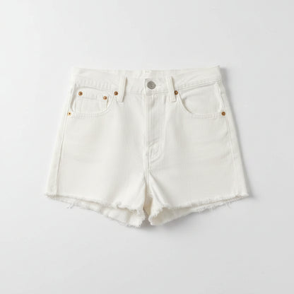 White denim shorts on a textured gray surface