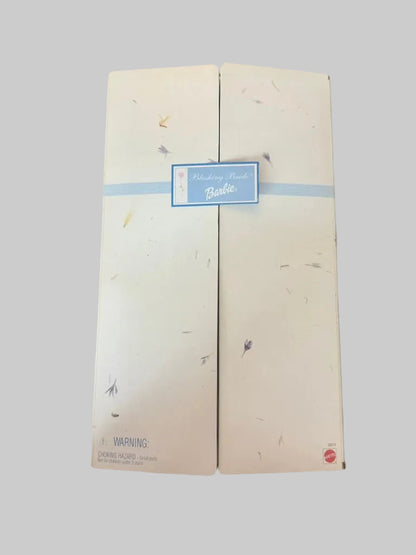 Two white boxes with a blue label on a wooden surface