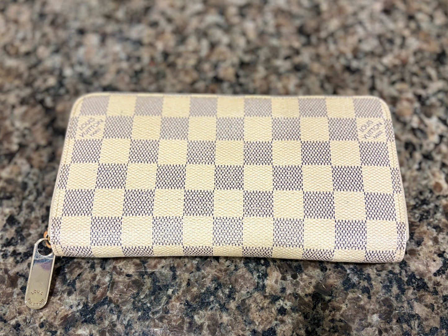 Checkered wallet on a granite surface
