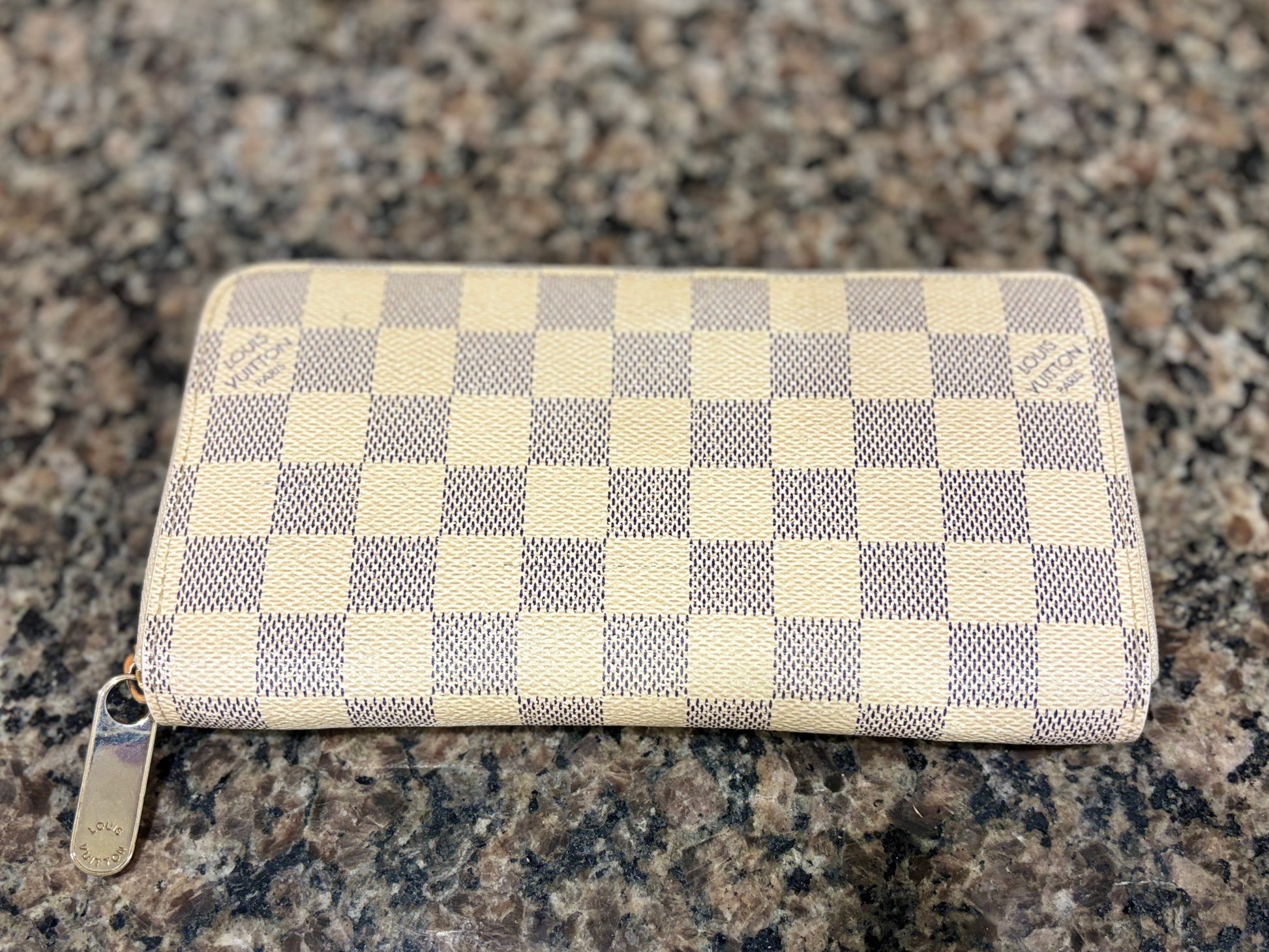 Checkered wallet on a granite surface
