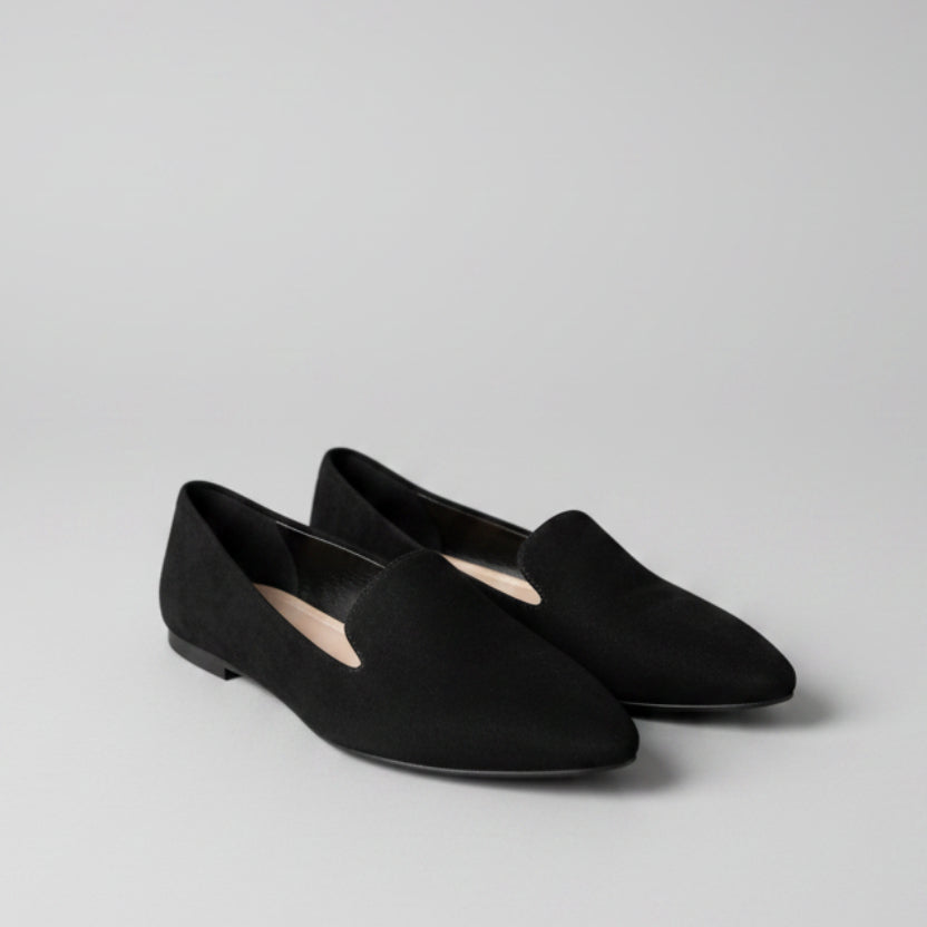Black shoes on a tiled floor with a blurred background