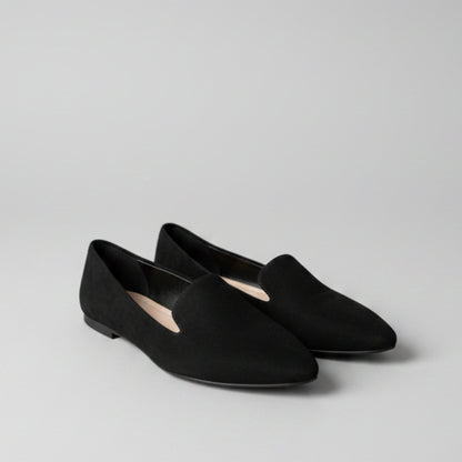 Black shoes on a tiled floor with a blurred background