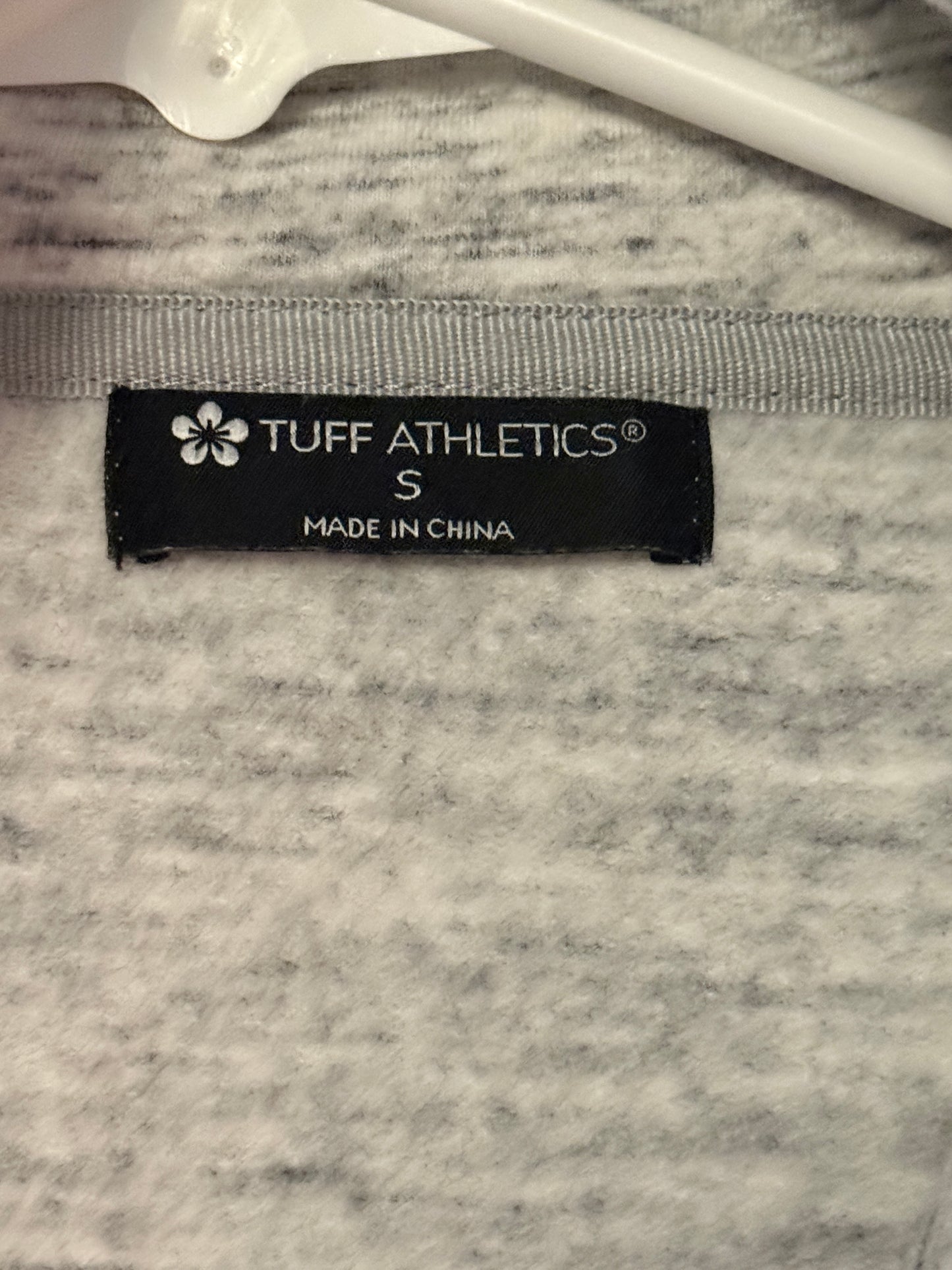 Gray athletic shirt with Tuff Athletics label on a textured surface