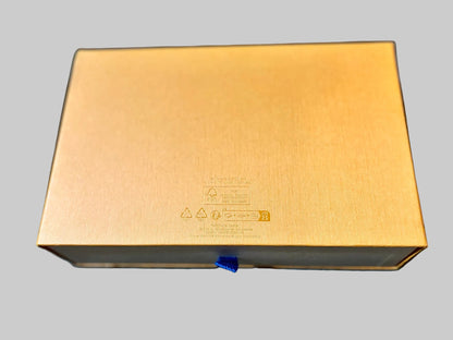 Gold-colored electronic device on a blue fabric background