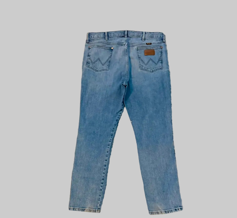 Blue jeans on a beige carpet